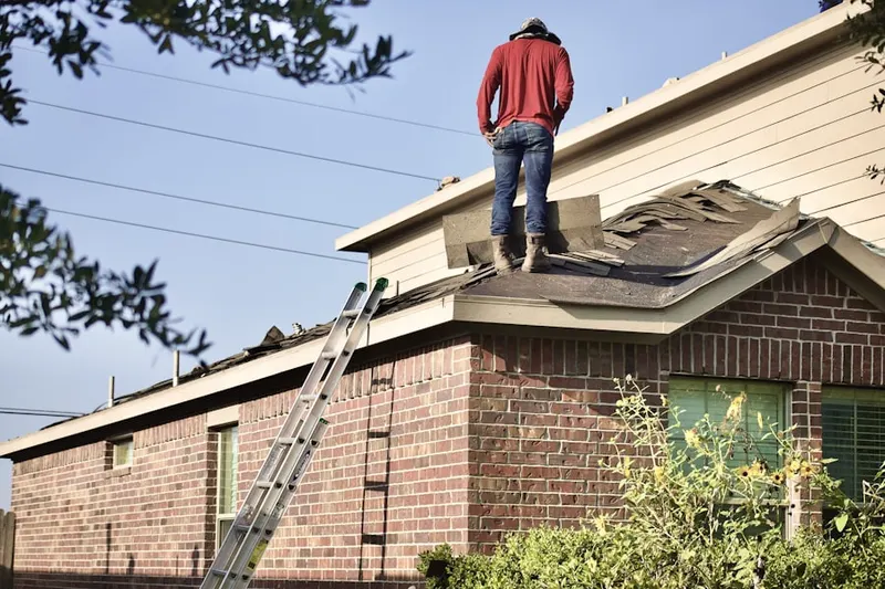 Professional roofer working on a residential roof in Fort Collins
